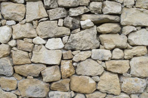 istock Old rural stone wall closeup in sunny day 1143705581