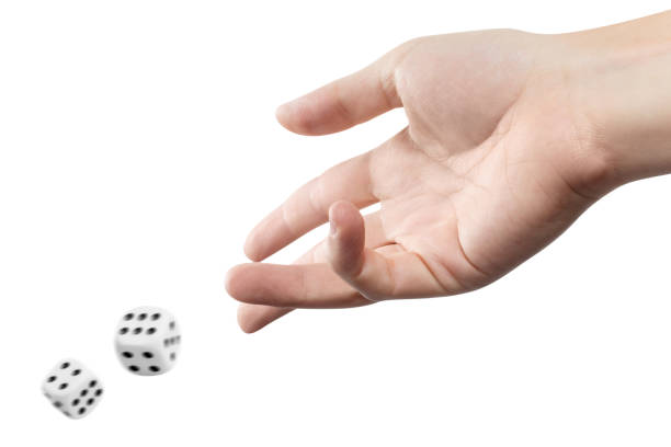 The dice game The dice game: hand throwing game cubes, isolated on white background dice stock pictures, royalty-free photos & images