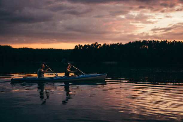 istock Summer relaxing activity. Young man kayaking on the lake 1143709057