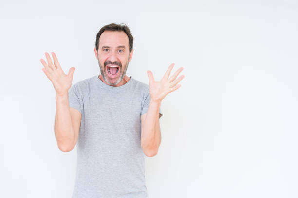 istock Handsome senior man over isolated background celebrating crazy and amazed for success with arms raised and open eyes screaming excited. Winner concept 1143709089