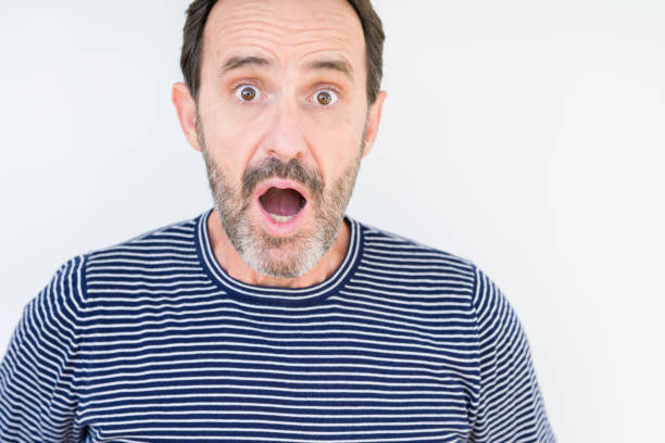 istock Handsome senior man over isolated background afraid and shocked with surprise expression, fear and excited face. 1143709107