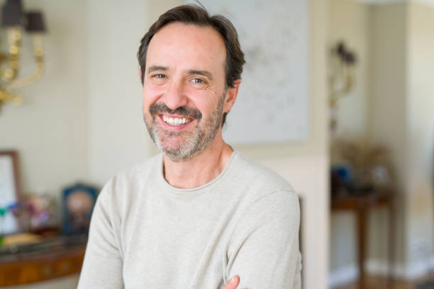 istock Handsome middle age man smiling looking at the camera at home 1143709241