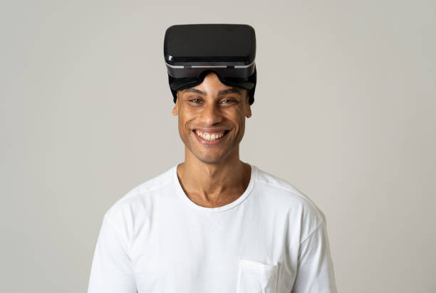 istock Virtual reality experience. Young african american young man happy to use VR goggles feeling excited about simulation and exploring virtual life. In New technology Virtual Augmented Reality concept. 1143710493