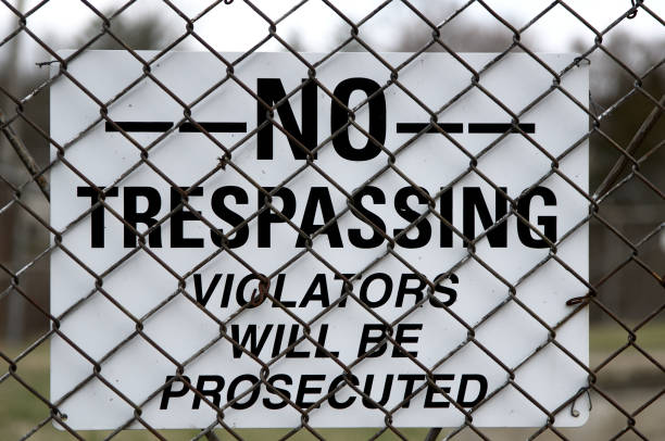 istock No Trespassing sign hung beind a fence 1143711180