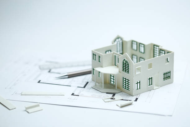 istock house model,blueprint,pencil and ruler on clean white background 1143712310