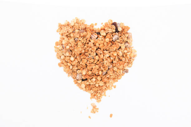 istock Heart from crispy muesli dry Breakfast isolated on white background selective focus, top view 1143712623