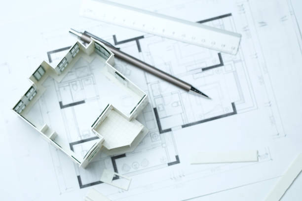 istock house model,blueprint,pencil and ruler on clean white background 1143713012