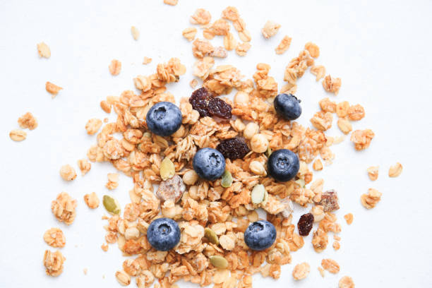 istock Crunchy muesli and blueberry Breakfast cereals isolated on white background, selective focus, top view 1143714911
