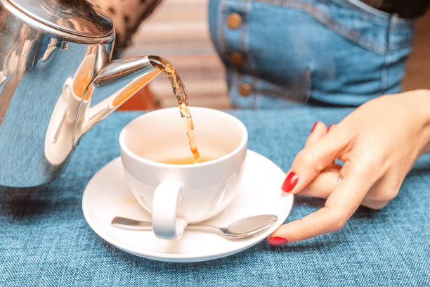 istock A woman pours tea from a kettle in a restaurant 1143716448