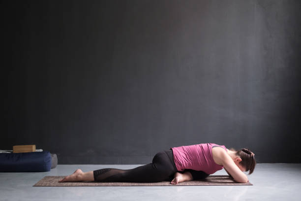 istock woman resting in One Legged King Pigeon Pose 1143716609