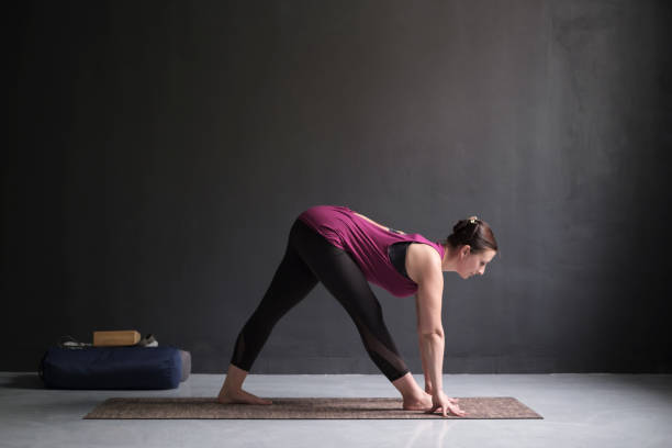 istock woman practicing yoga, doing Half Pyramid or Parshvottanasana 1143716877
