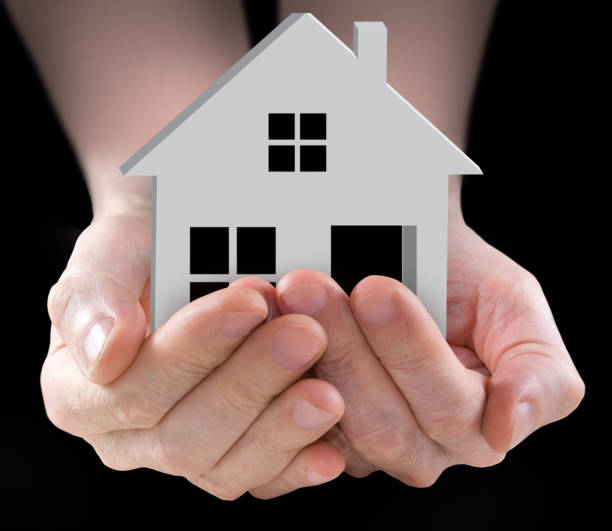 istock image of stylized house in the hands 1143716972