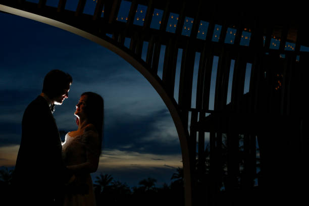 istock Beutiful wedding couple posing in sunset near beach 1143717018