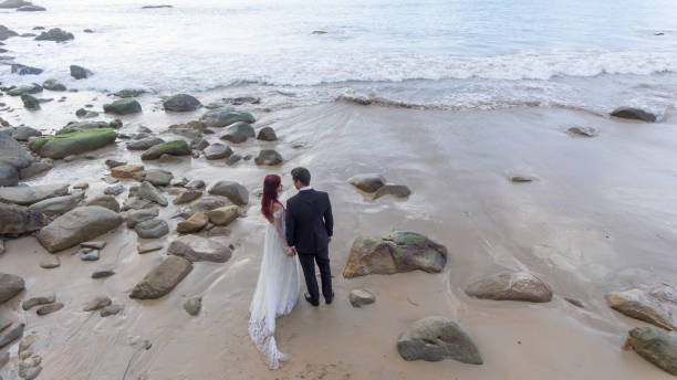 istock Happy wedding couple posing on beach 1143717780