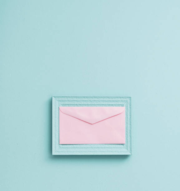 istock Space pastel vintage picture frame with pink envelope 1143717936