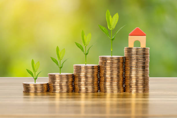 istock Mini model house on coins stack concept for mortgage, finance, and saving 1143718050