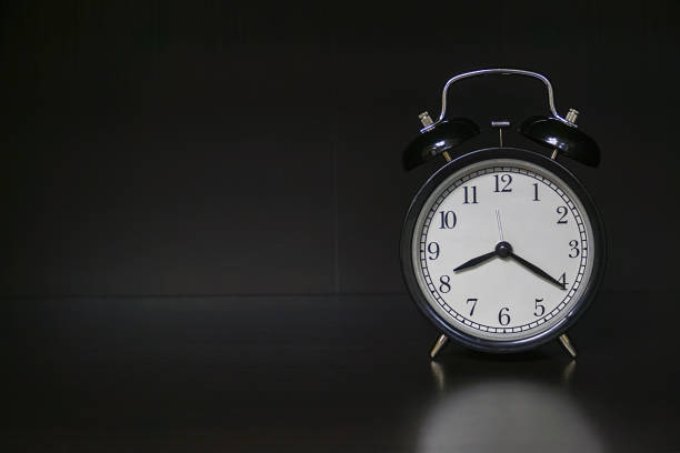 istock Classic alarm clock on dark background 1143718186