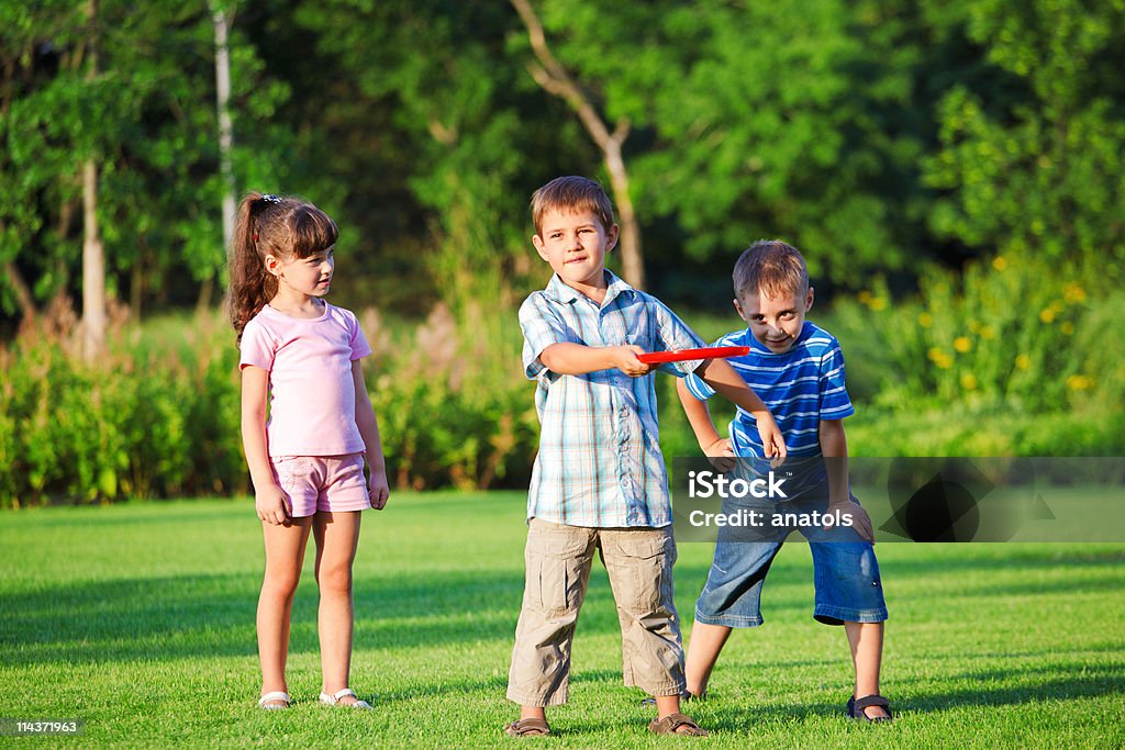 Kids playing freesbee  Plastic Disc Stock Photo