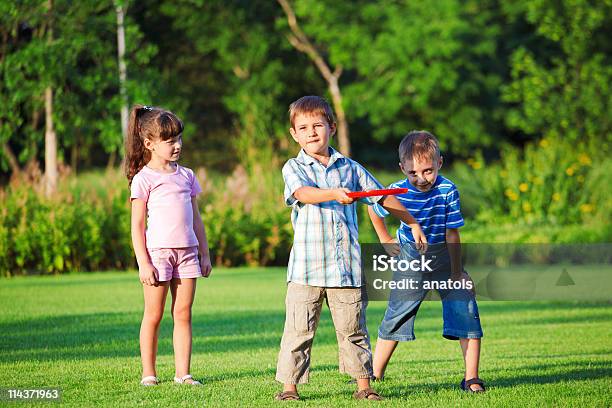Kids Playing Freesbee Stock Photo - Download Image Now - Plastic Disc, Playful, Playing