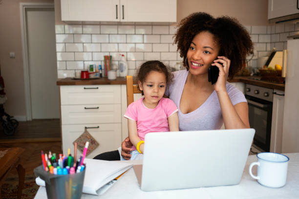 istock Mother and daughter using laptop at home 1143720524