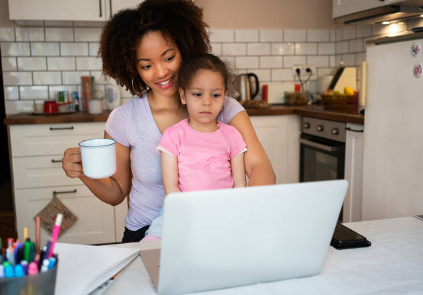 istock Mother and daughter using laptop at home 1143720701