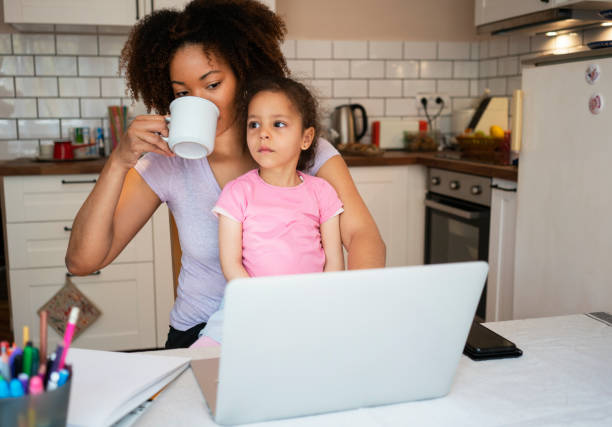 istock Mother and daughter using laptop at home 1143720792