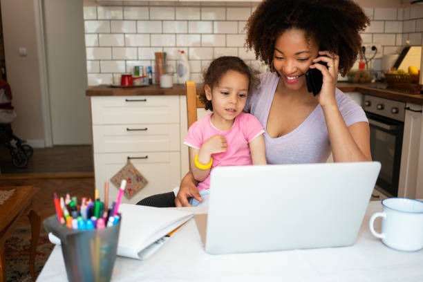istock Mother and daughter using laptop at home 1143720847