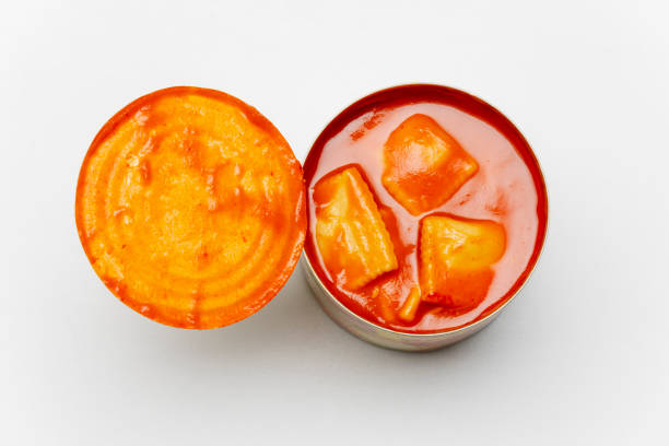 open can of ravioli on white background