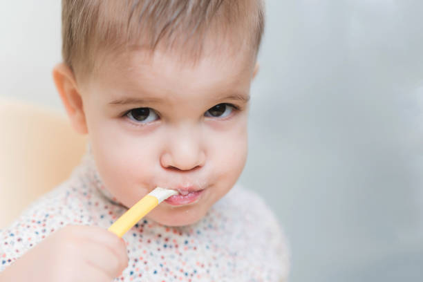 istock the kid in the kitchen eats milk porridge 1143722529