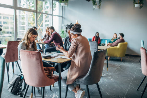 Group of friends working in cafe