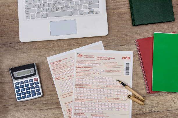 istock Australian tax declaration with laptop and calculator on the table 1143726048