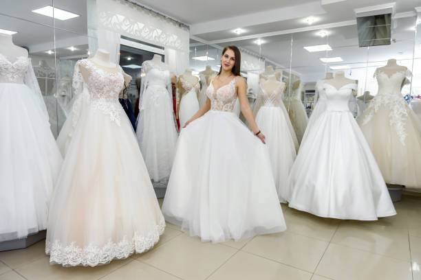 istock Bride in wedding dress fitting it in atelier 1143726249