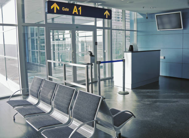istock Closed boarding gate with empty seating in airport terminal 1143727205