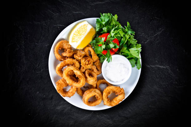 istock Fried calimari rings on black background 1143727279