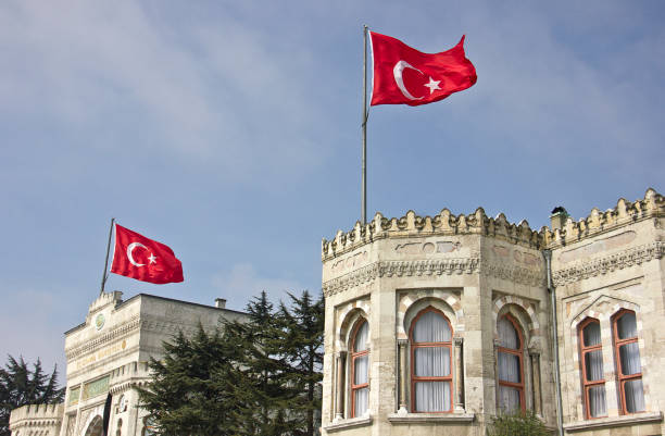Istanbul, Turkey - March 16, 2019: People rest and socialize in Beyazit Square, on the background the main gate of the historical Istanbul University located in Istanbul, Turkey.