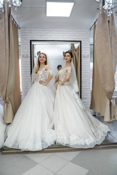 istock Happy brides in wedding dresses posing in salon 1143728234
