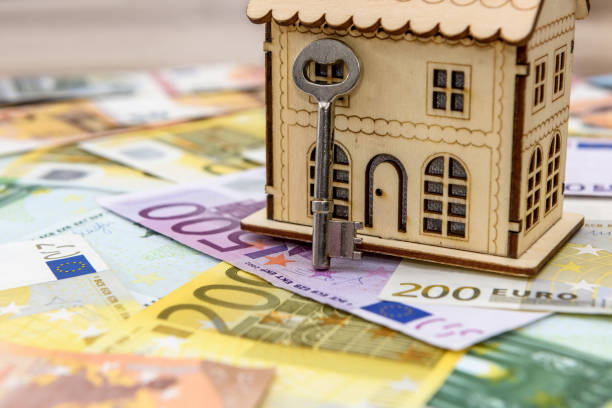 istock Euro banknotes as background for small toy house 1143728310