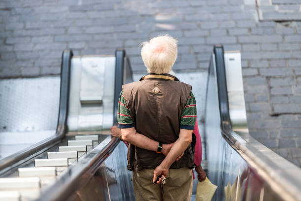Perugia, Italy - August 29, 2018: Man riding escalator down to parking lot in Umbria