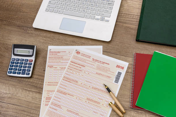 istock Australian tax declaration with laptop and calculator on the table 1143728538