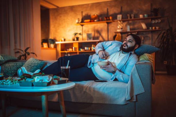 istock Fat man eating fast food 1143729315