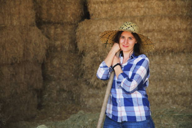 istock Farmers working with hay in barn 1143729488