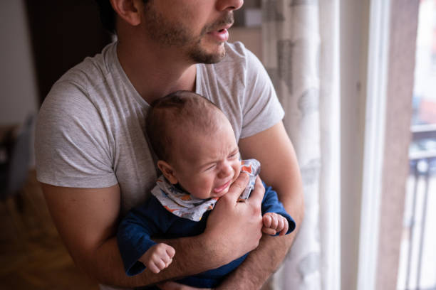 istock Crying baby in father's arms 1143730902