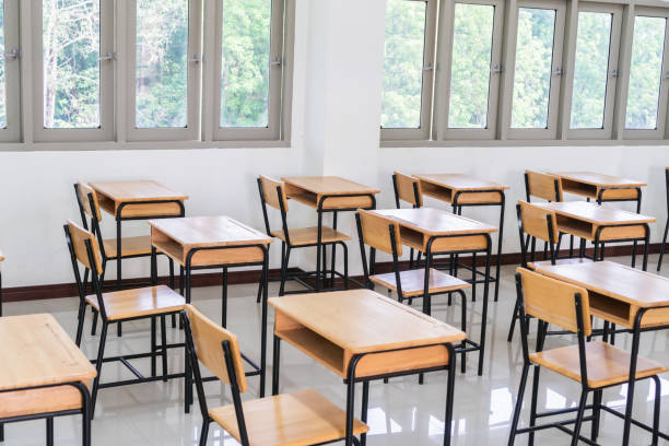 istock School empty classroom or lecture room interior with desks chair iron wooden whiteboard for studying lessons of secondary education in high school thailand. Learning and Back to school concept 1143733662