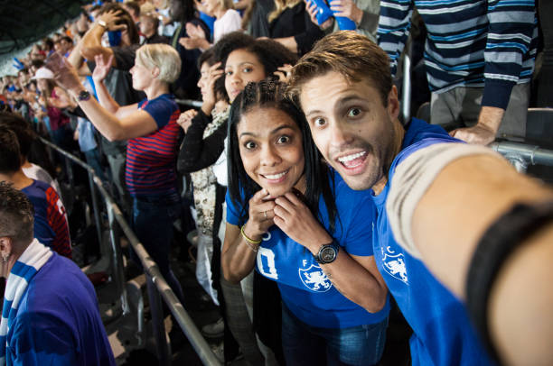 istock Young couple at footbal match making a selfie 1143734280