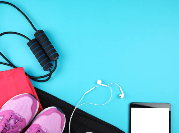istock electronic tablet with empty white screen, next to it is fitness clothes 1143735349