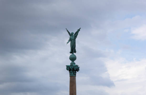 istock Angel statue on the column with blue sky 1143735440