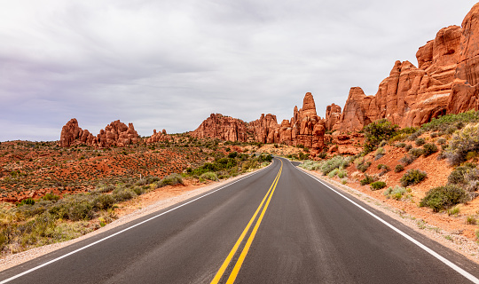 A scenic route through rock formations in Arches National Park in Utah.