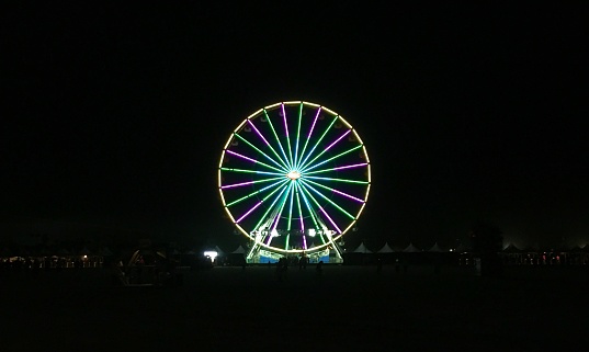 A colorful let Ferris wheel at night