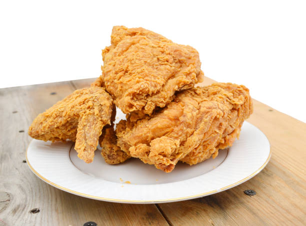 istock Fried chicken in plate on wooden board on white 1143743148