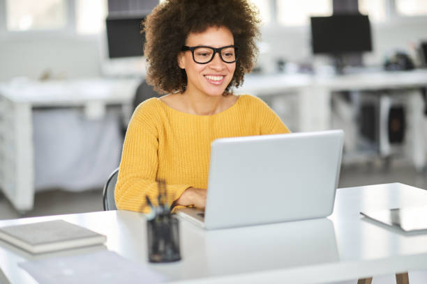 istock Smiling businesswoman using laptop in modern office. 1143744292